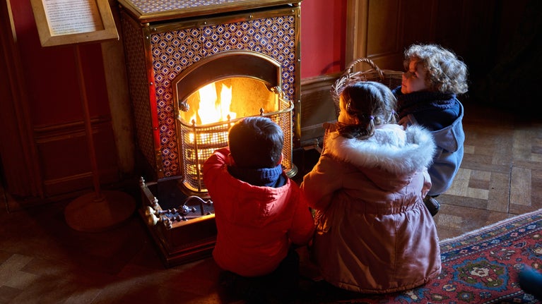 Children gathered around the fire at Hughenden Manor